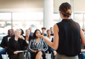 Shot of a young businesswoman delivering a speech during a conference